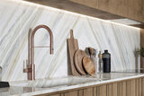 Ajax Gold natural marble slab with honed finish, showcasing soft gold and beige veining on a light neutral background—ideal for elegant countertops, flooring, and wall applications.