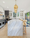 Ajax Gold natural marble slab with honed finish, showcasing soft gold and beige veining on a light neutral background—ideal for elegant countertops, flooring, and wall applications.